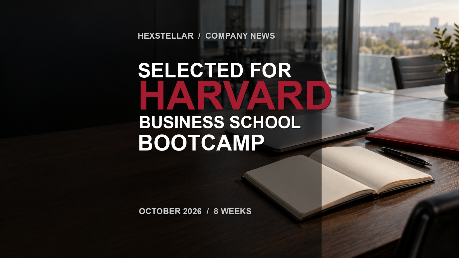 A clean boardroom table with a closed laptop, open blank notebook, crimson folder, and the words Selected for Harvard Business School Bootcamp.
